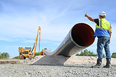 Eine Baumaschine verlegt Rohre für die LNG-Anbindung Eine Baumaschine verlegt Rohre für die LNG-Anbindung